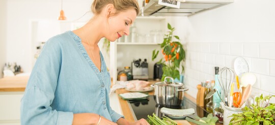 Frau schneidet Gemüse - Gesunde und ausgewogene Ernährung hat großen Einfluss auf Hauterkrankungen